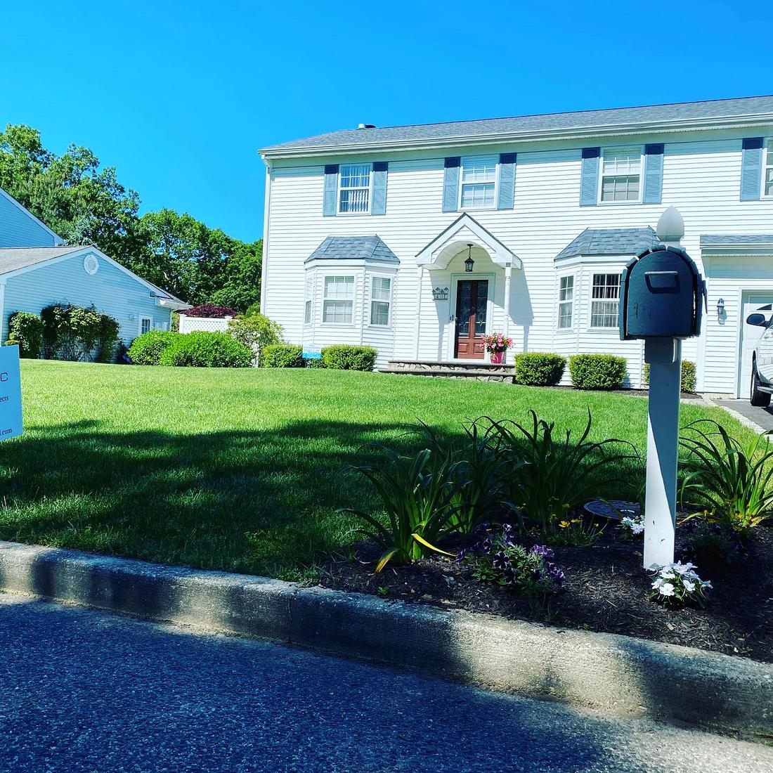 Front lawn of a white colonial house