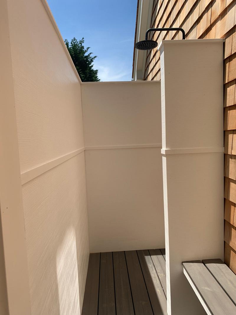 Outdoor shower with a built-in bench