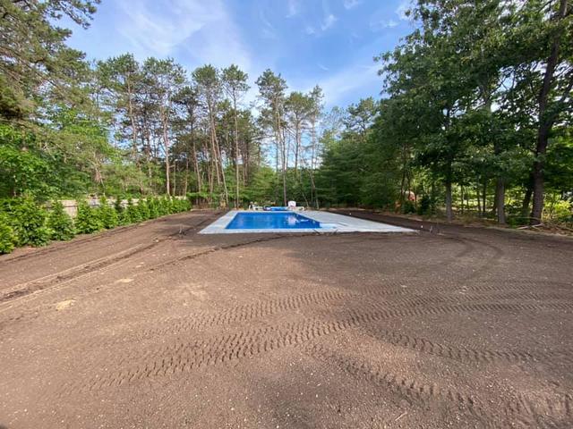 Before: a new pool with a bare dirt yard