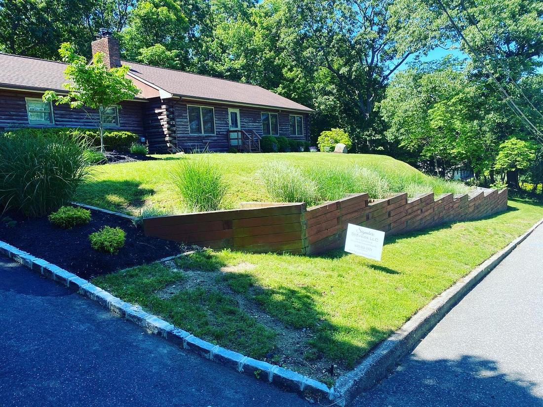 Sloped lawn above a timber retaining wall